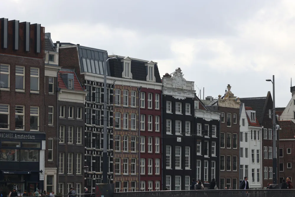 Classic gabled Amsterdam canal-house facades along a city bridge – best areas to stay for ADE first-timers