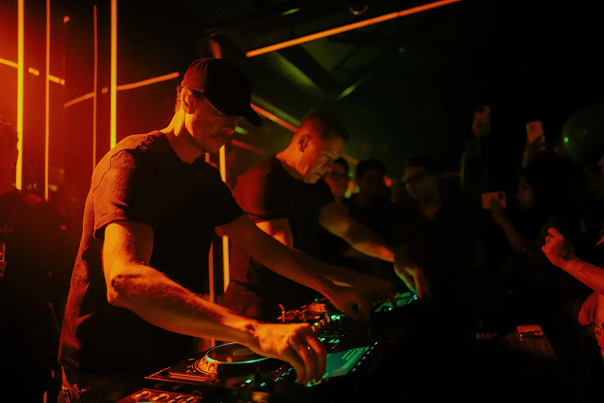 DJ performing under vibrant club lighting – the range of music and showcases across the ADE program