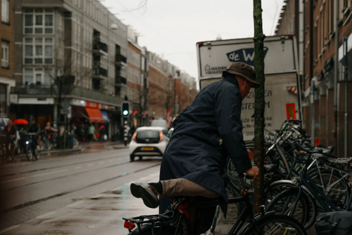 Bicycles parked on a rainy Amsterdam street with Dutch architecture – what to pack for October ADE weather