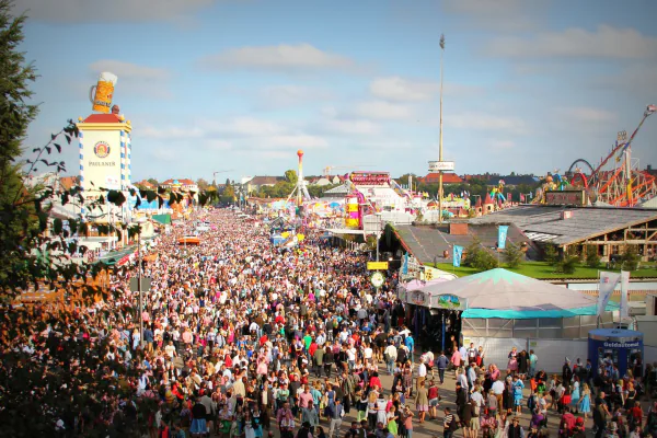 Aerial view of the packed Theresienwiese fairground with funfair rides and beer tents - beyond the beer tents at Munich Oktoberfest 2026