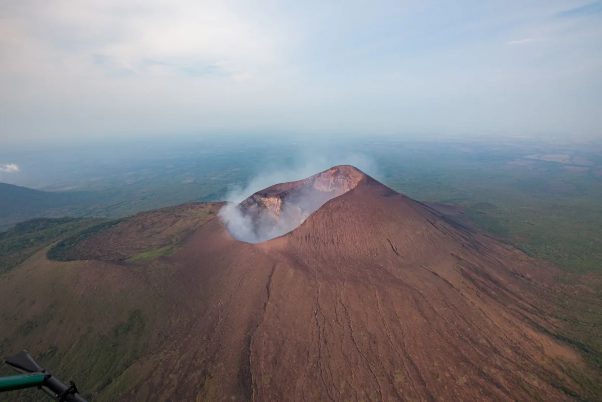 Smoke drifting from neighbouring Telica volcano's crater – volcano boarding safety and insurance, Leon, Nicaragua