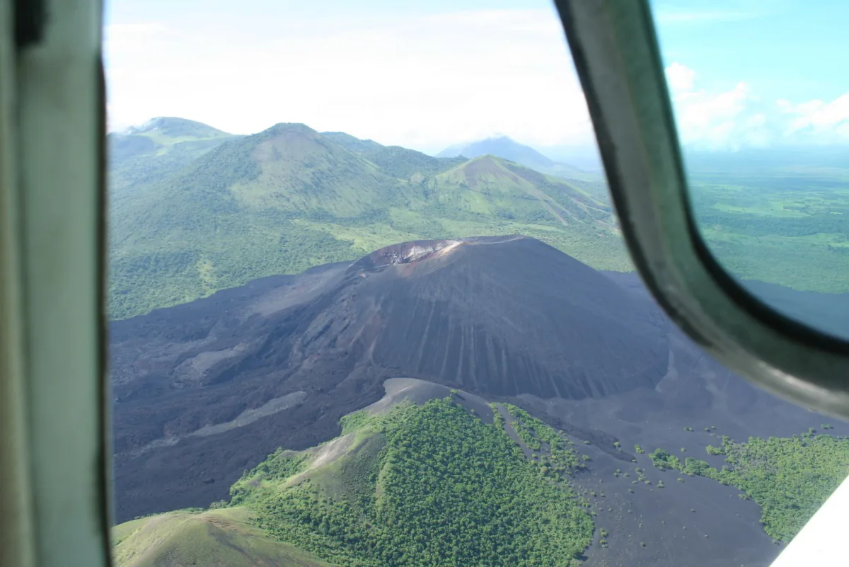 Cerro Negro's dark cone ringed by green rainy-season hills – when to go and what to pack, Leon, Nicaragua