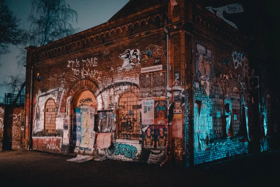 Abandoned urban building in Berlin with colorful graffiti and posters at night. – Can you actually go clubbing sober in Berlin?