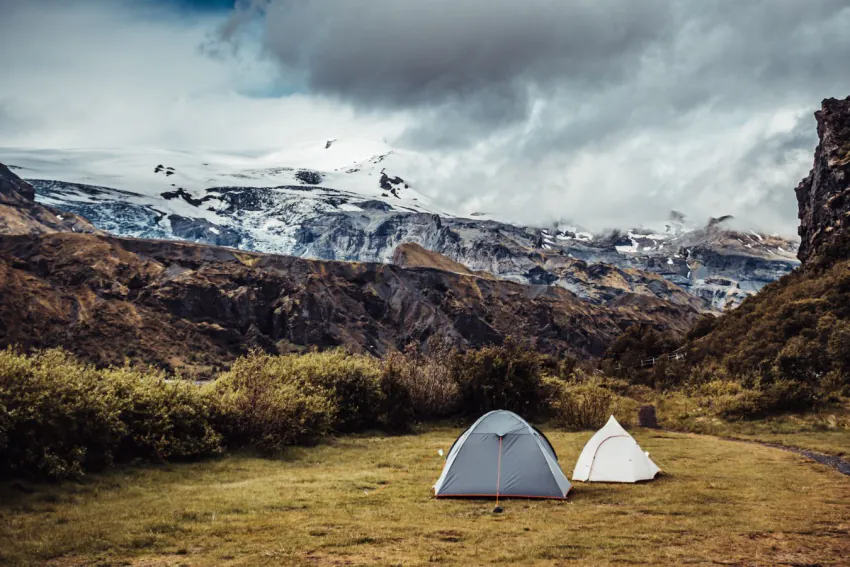 Tents pitched at a highland campsite below a glacier – Laugavegur huts vs camping, Iceland