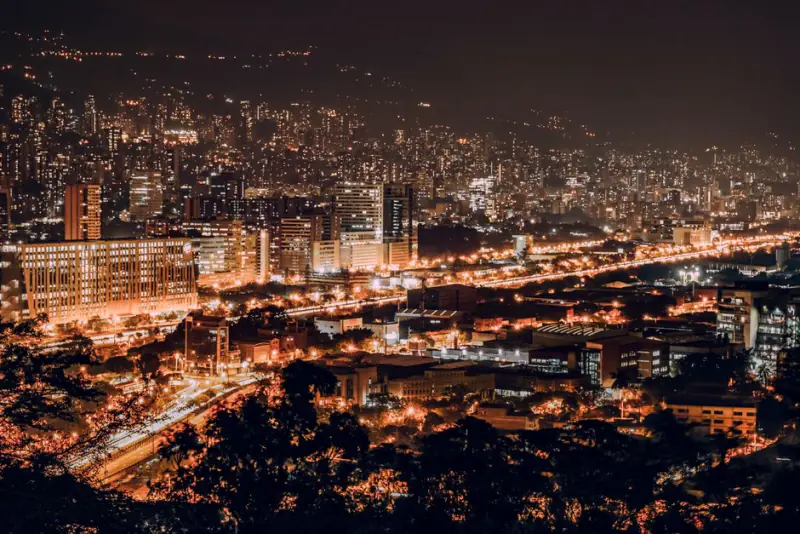 A vibrant night view of Medellin, Colombia with illuminated buildings and city lights. – Is Medellin Nightlife Safe in 2026?
