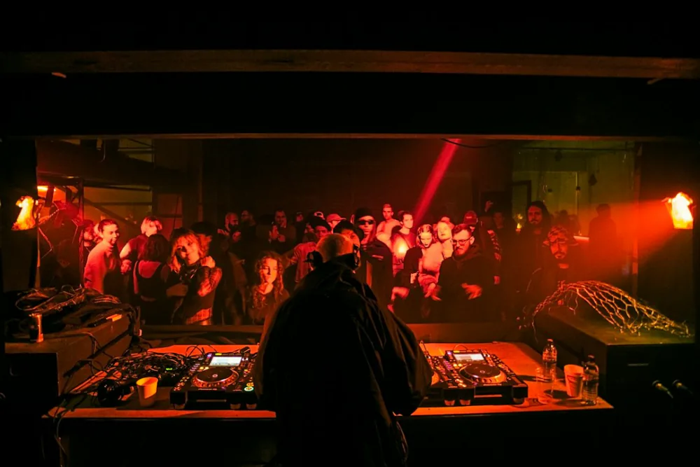 DJ playing to a packed dark crowd – the underground club atmosphere of Bassiani, Tbilisi