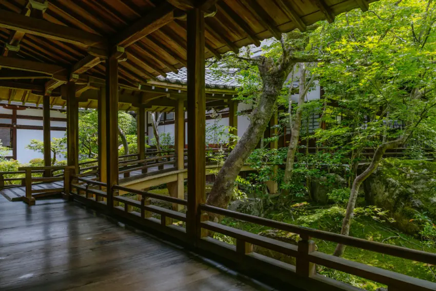 Polished wooden ryokan corridor leading to the baths past a maple garden – common visitor mistakes section, Japan