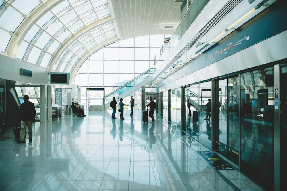 Travellers with suitcases waiting on the airport metro platform – the verdict on self-transfer flights, Dubai International