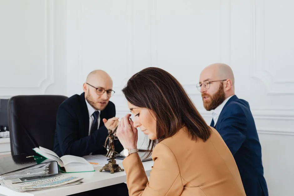 Client and advisers reviewing paperwork at an office table – what happens when an extreme sports claim is denied