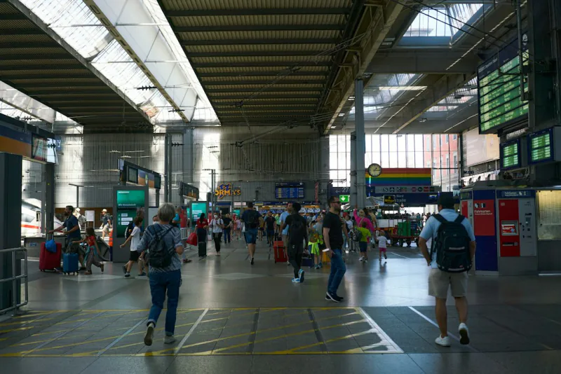 a group of people walking in a large building – How Much Do Night Trains Cost in 2026?