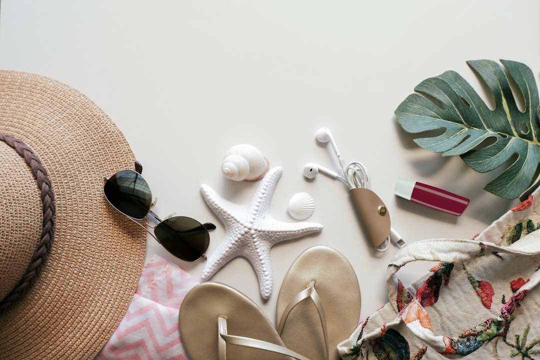 Summer essentials arranged on a white surface – What to Actually Pack for a Nude Cruise